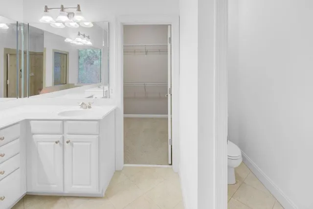 a bathroom with a sink vanity and a mirror