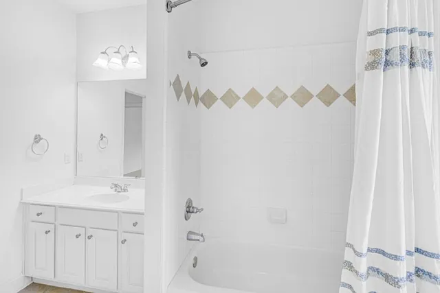 a bathroom with a sink a mirror and a shower