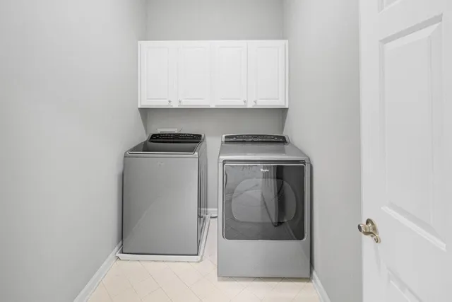 a utility room with wooden floor washer and dryer