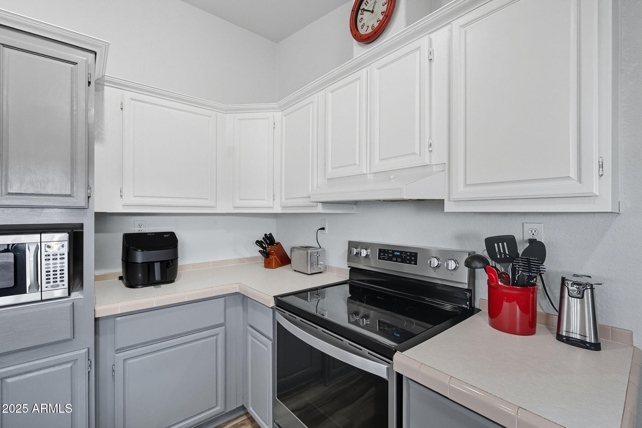 3700 South Tomahawk Road, Unit 39 Apache Junction, AZ 85119 - Photo 24 of 53 a kitchen with a microwave and cabinets