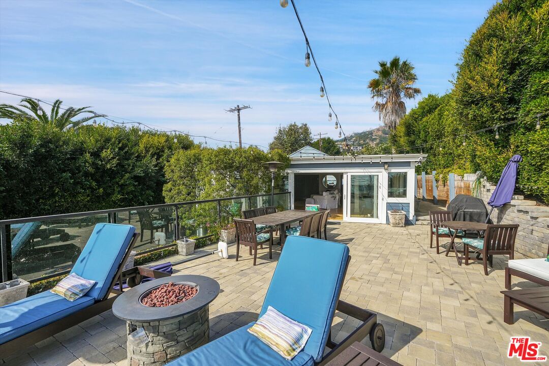3966 Las Flores Canyon Road Malibu, CA 90265 - Photo 17 of 53 a view of a patio with couches table and chairs and potted plants