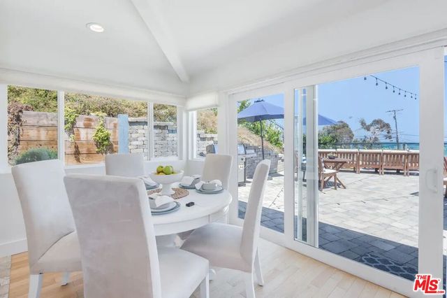 a dining room with furniture water view and wooden floor