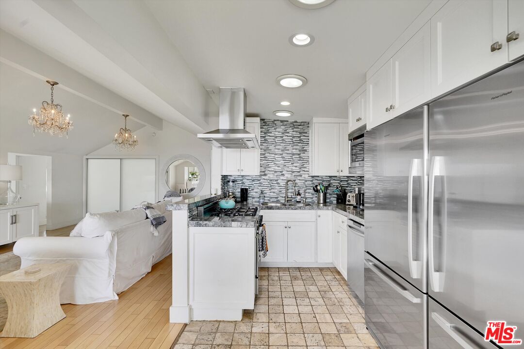 3966 Las Flores Canyon Road Malibu, CA 90265 - Photo 21 of 53 a kitchen with a sink a refrigerator and cabinets