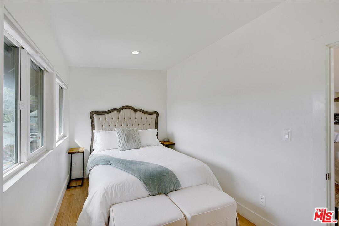 3966 Las Flores Canyon Road Malibu, CA 90265 - Photo 40 of 53 a bedroom with a bed and a painting on the wall