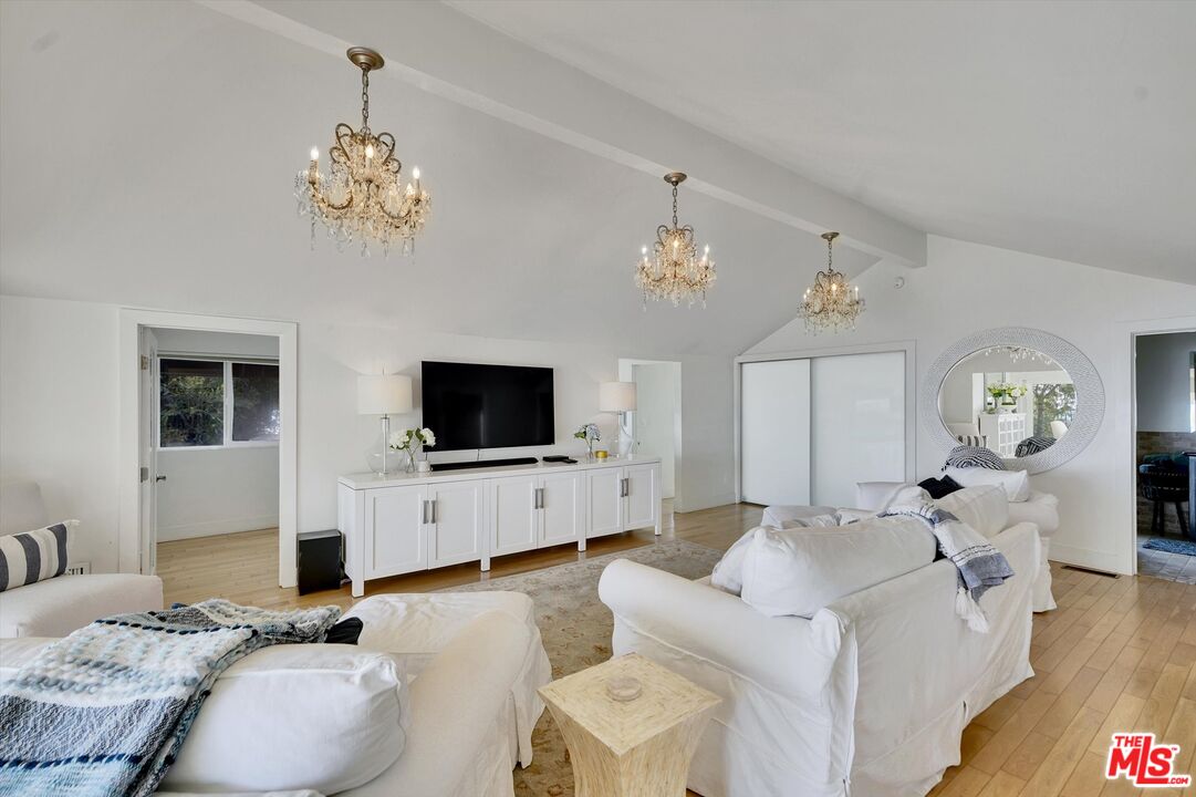 3966 Las Flores Canyon Road Malibu, CA 90265 - Photo 4 of 53 a living room with furniture a fireplace and a flat screen tv