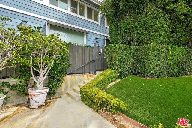a view of a backyard with plants and garden