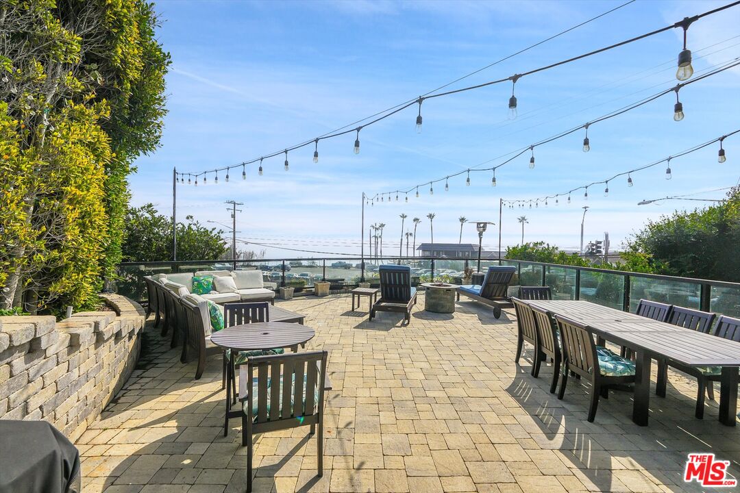 3966 Las Flores Canyon Road Malibu, CA 90265 - Photo 9 of 53 a view of a patio with a dining table and chairs
