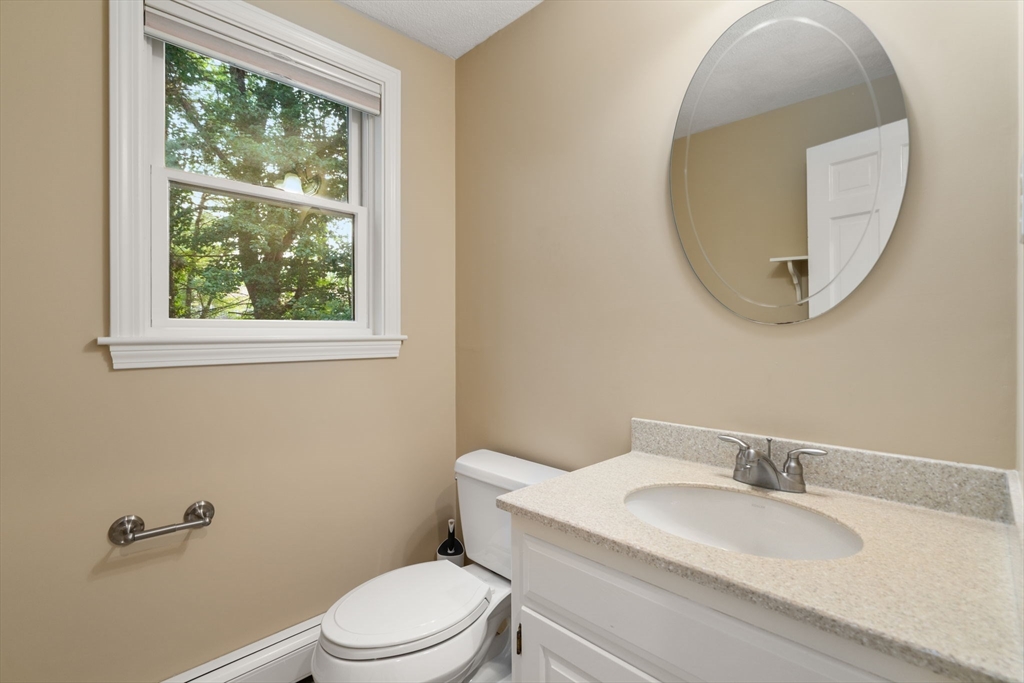 1 Pueblo Road Medfield, MA 02052 - Photo 13 of 36 a bathroom with a granite countertop toilet a sink and mirror