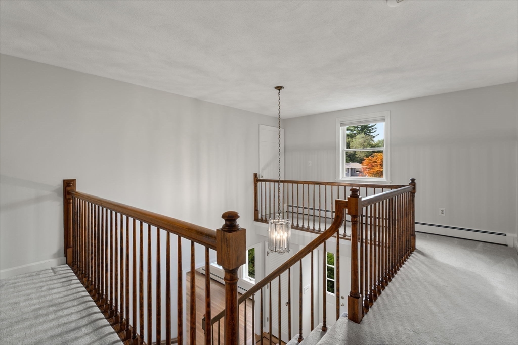 1 Pueblo Road Medfield, MA 02052 - Photo 20 of 36 a view of a hallway with wooden floor and stairs