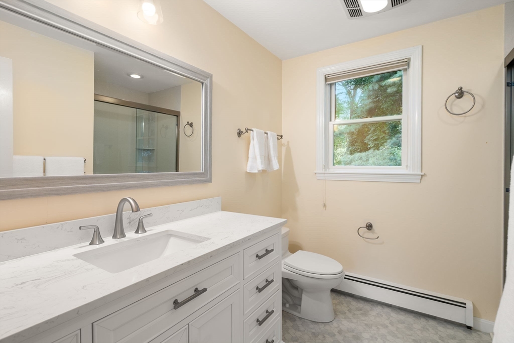 1 Pueblo Road Medfield, MA 02052 - Photo 23 of 36 a bathroom with a toilet a sink a mirror and a window
