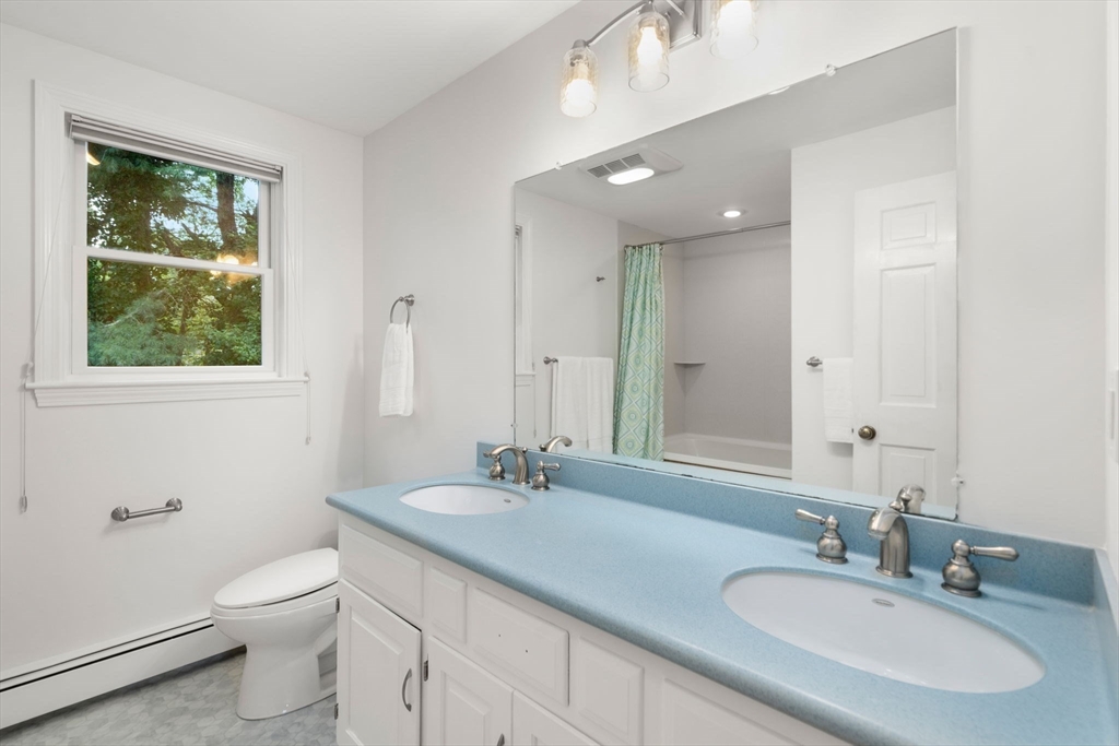 1 Pueblo Road Medfield, MA 02052 - Photo 24 of 36 a bathroom with a granite countertop sink a toilet and a mirror