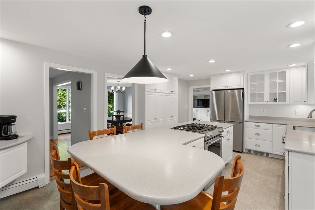 1 Pueblo Road Medfield, MA 02052 - Photo 10 of 36 a kitchen with stainless steel appliances a dining table chairs and stove top oven