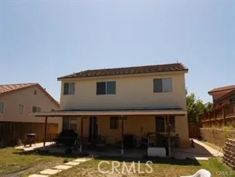 a backyard of a house with yard fire pit and outdoor seating