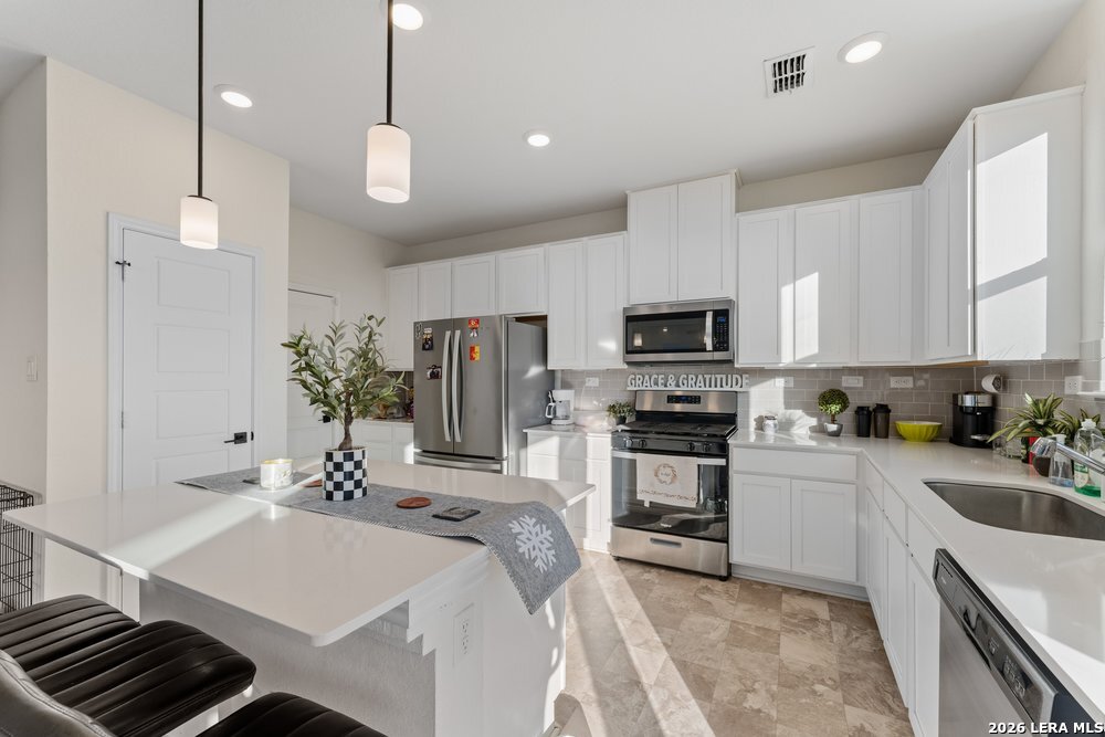 9422 Braman Converse, TX 78109 - Photo 14 of 26 a kitchen with a sink stainless steel appliances and cabinets