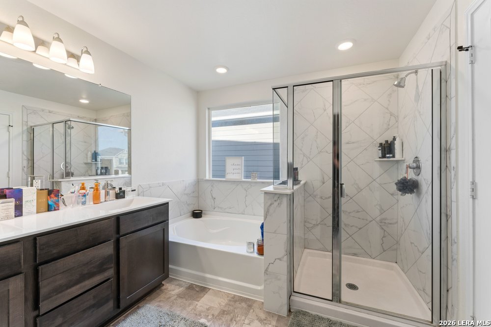 9422 Braman Converse, TX 78109 - Photo 19 of 26 a bathroom with a bathtub shower sink vanity and toilet