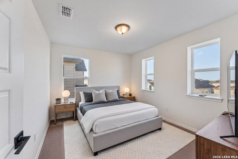 9422 Braman Converse, TX 78109 - Photo 20 of 26 a bedroom with a bed and night stand