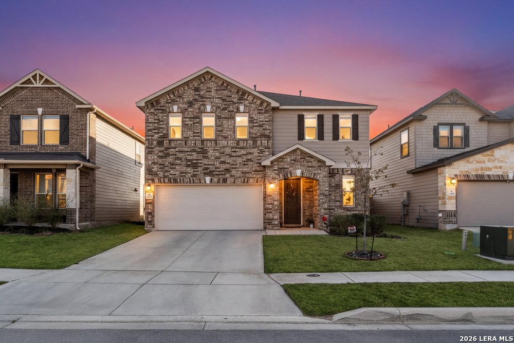 9422 Braman Converse, TX 78109 - Photo 2 of 26 a front view of a house with a yard and garage
