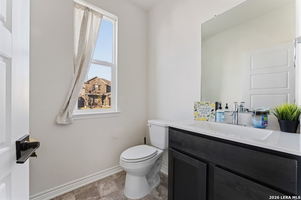 9422 Braman Converse, TX 78109 - Photo 24 of 26 a bathroom with a toilet a sink and mirror