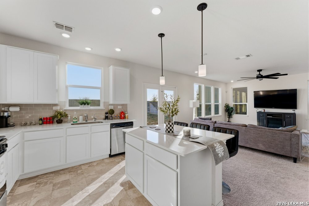 9422 Braman Converse, TX 78109 - Photo 7 of 26 a kitchen with stainless steel appliances kitchen island granite countertop a sink and a couch