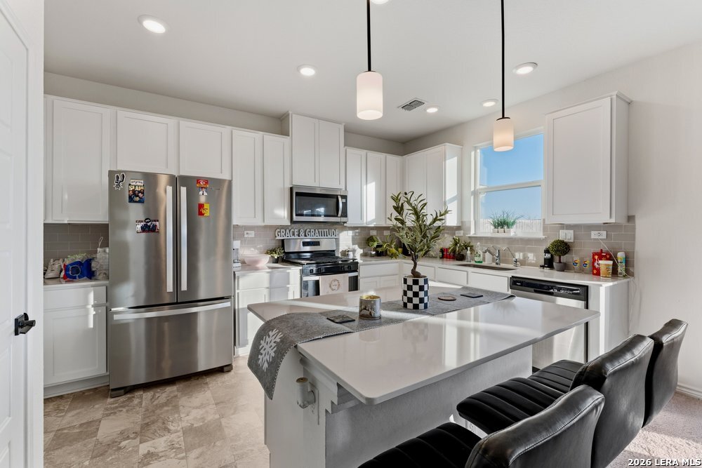 9422 Braman Converse, TX 78109 - Photo 8 of 26 a kitchen with kitchen island a counter space a sink appliances and cabinets