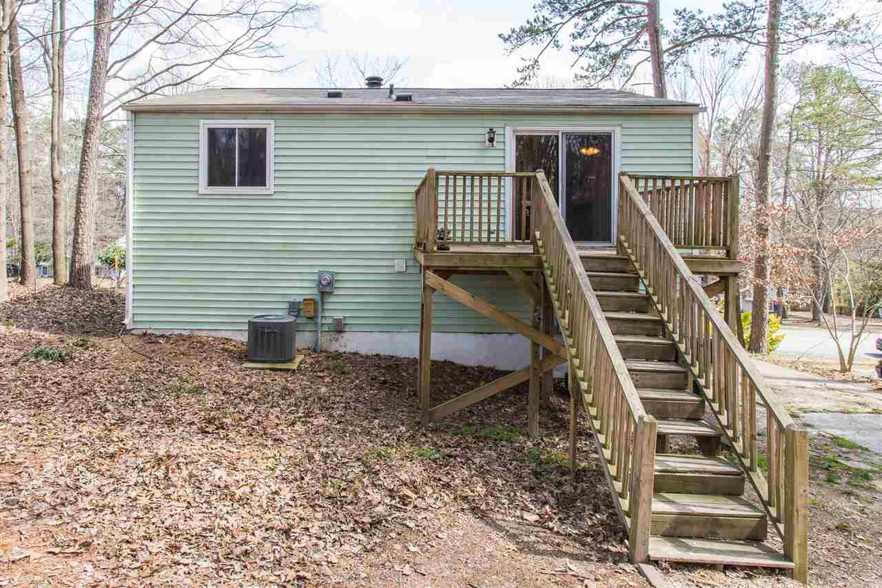 8005 Mourning Dove Road Raleigh, NC 27615 - Photo 20 of 22 A sunny deck off the kitchen welcomes you into the low maintenance backyard. Exterior Back