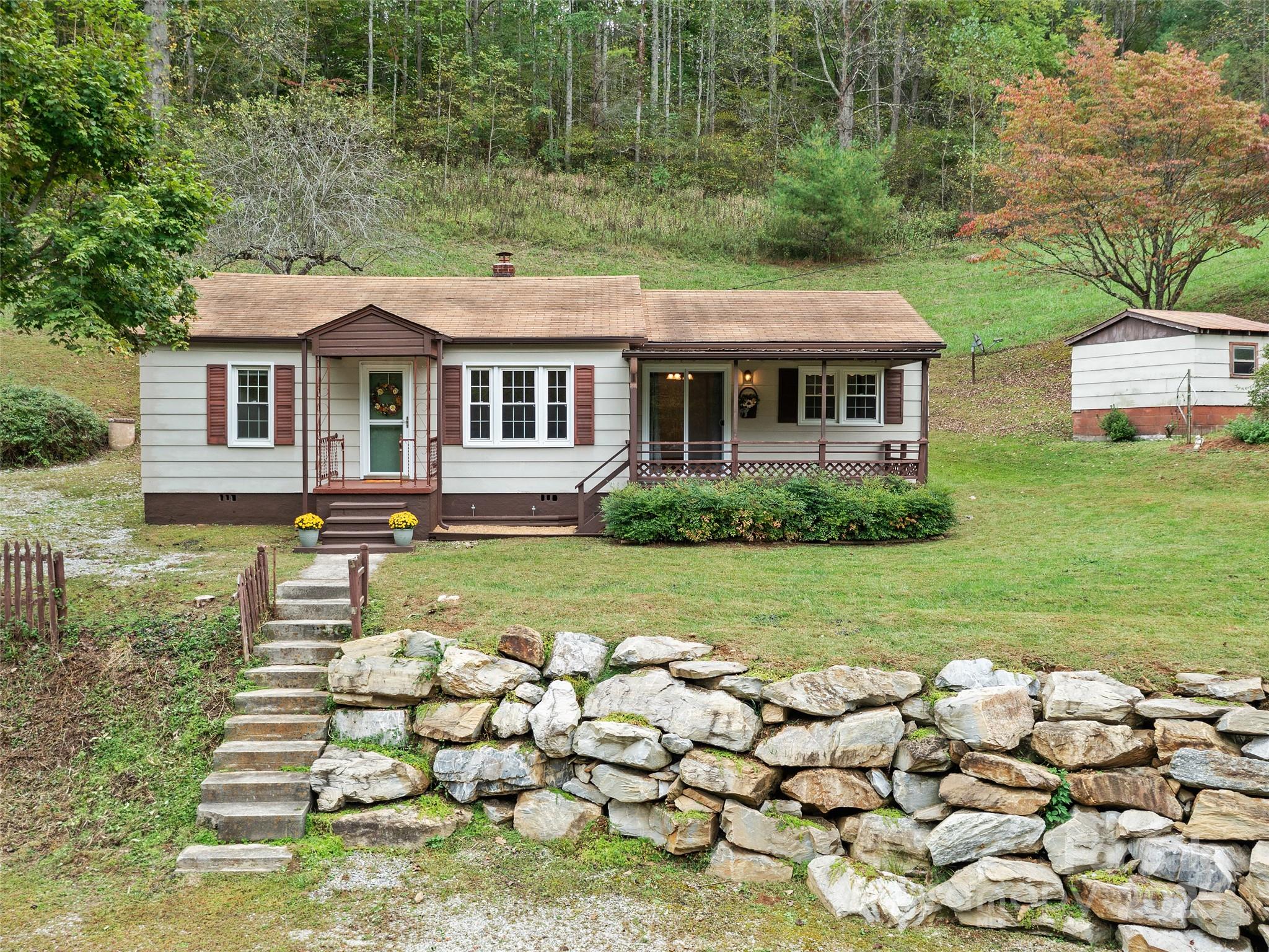 338 Sweet Creek Road Bakersville, NC 28705 - Photo 1 of 21 a front view of a house with garden