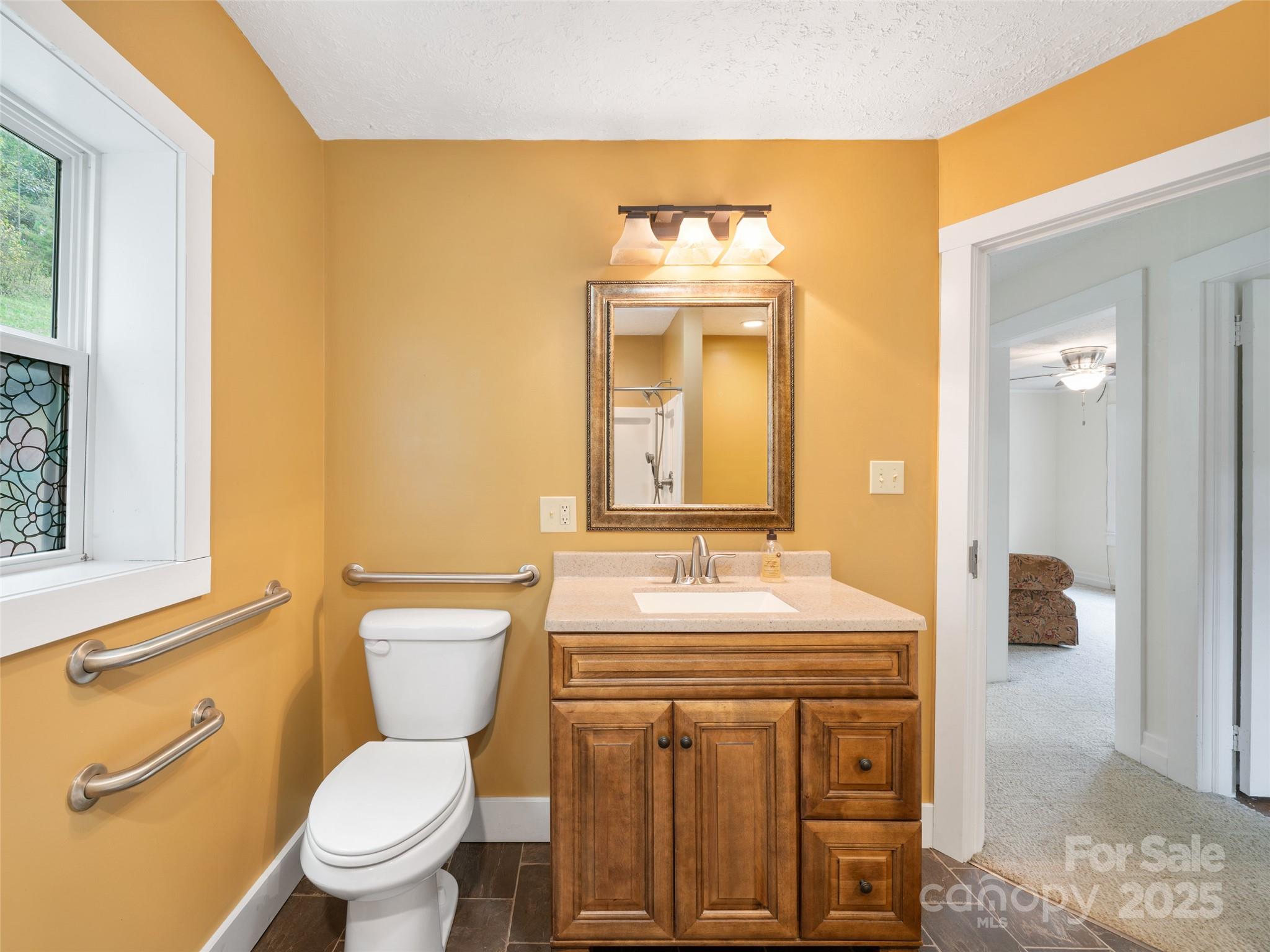 338 Sweet Creek Road Bakersville, NC 28705 - Photo 15 of 21 a bathroom with a toilet a sink and a mirror