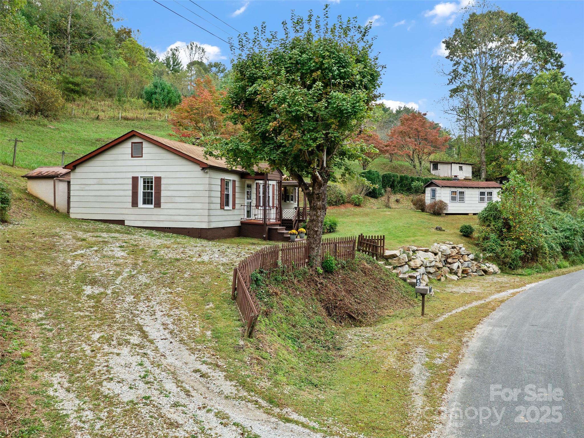 338 Sweet Creek Road Bakersville, NC 28705 - Photo 19 of 21 a view of a house with a yard