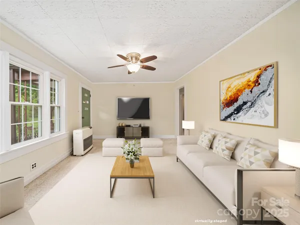 a living room with furniture a flat screen tv and a large window