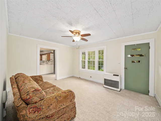 a living room with furniture and ceiling fan