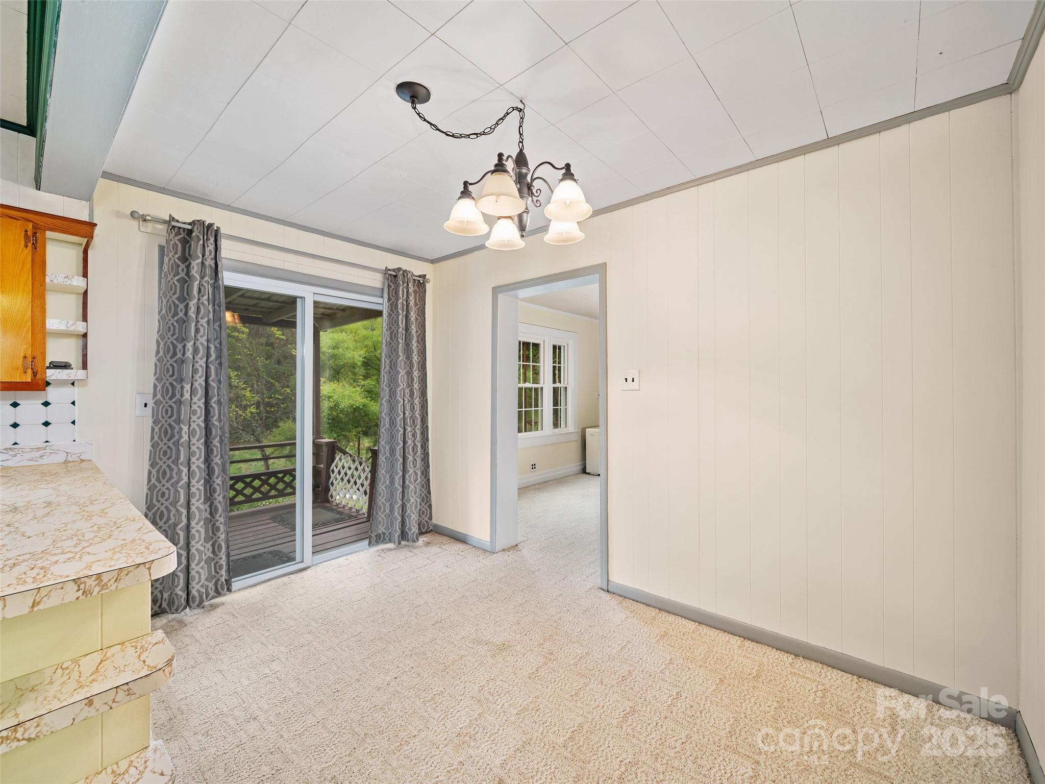 338 Sweet Creek Road Bakersville, NC 28705 - Photo 7 of 21 a view of a livingroom with wooden floor and windows