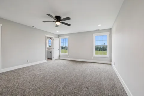 a view of a livingroom with a ceiling fan and window