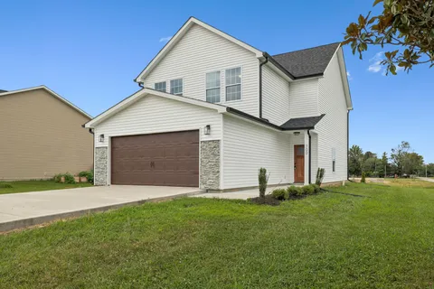 a front view of a house with a yard and garage