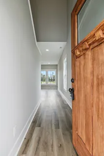 a view of hallway with wooden floor