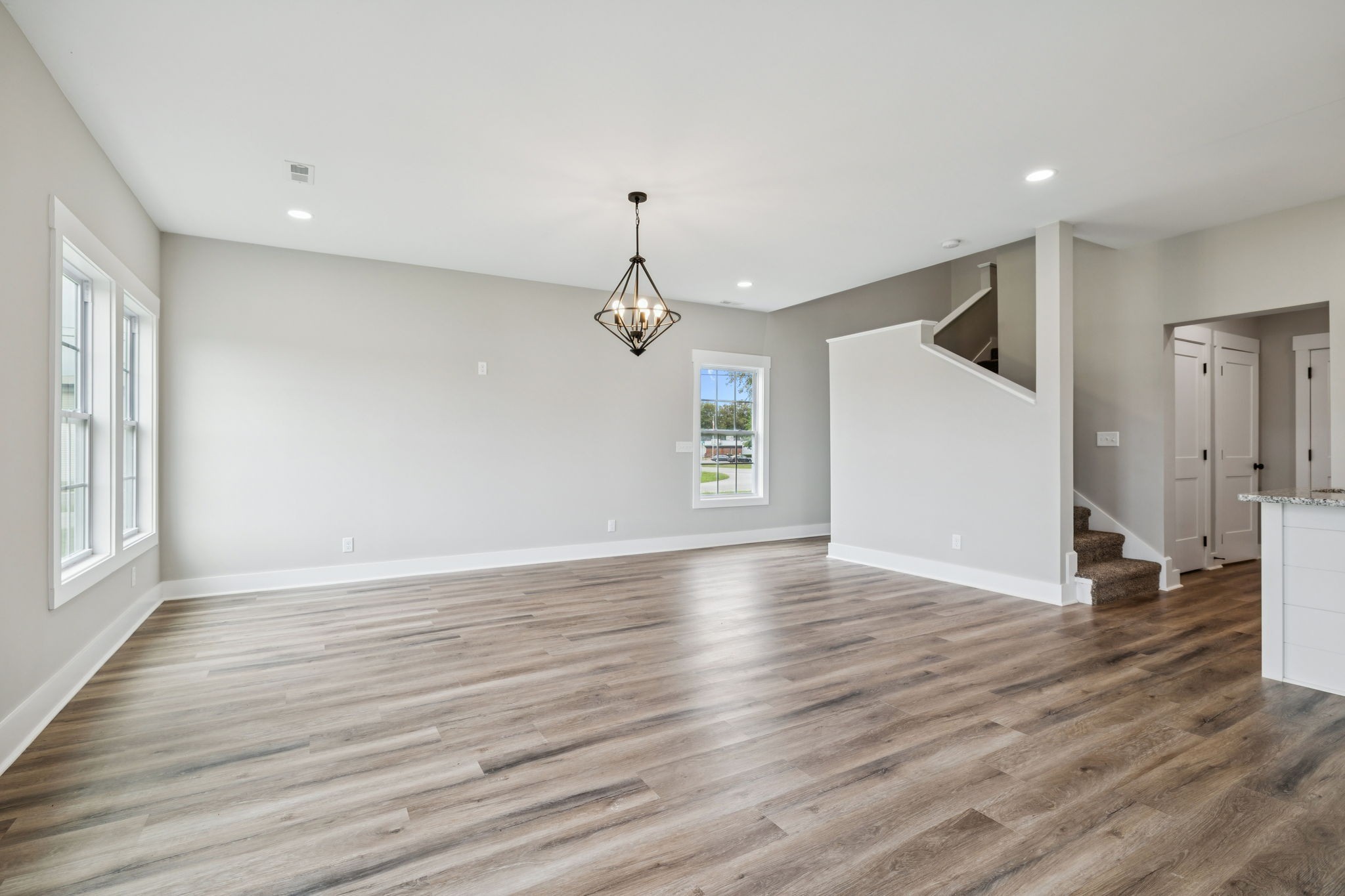 700 Robinson Road Smithville, TN 37166 - Photo 9 of 36 a view of a livingroom with wooden floor staircase and a kitchen space