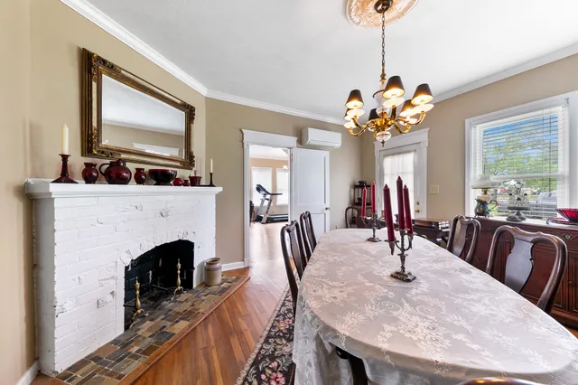 a view of a a dining room with furniture window and wooden floor