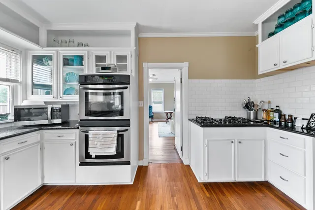 a kitchen with a sink stove and cabinets
