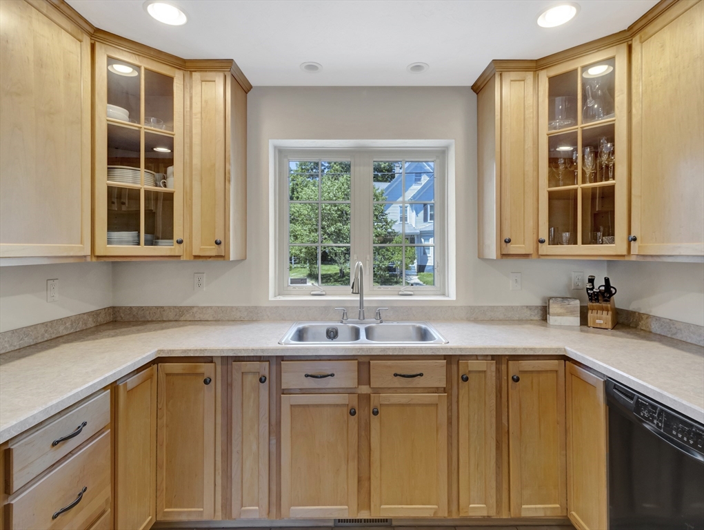 13 Shawmut Avenue, Unit 13 Mansfield, MA 02048 - Photo 10 of 34 a kitchen with stainless steel appliances granite countertop a sink window and cabinets