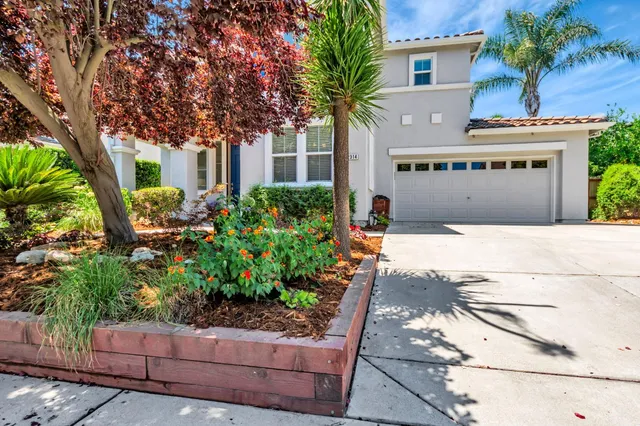 a front view of a house with a garden