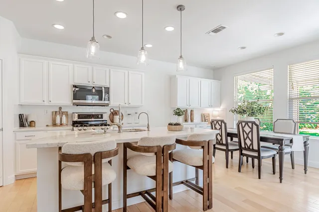 a living room with furniture a table and a large window