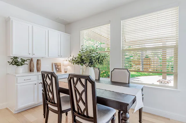 a view of a hallway with wooden cabinet and windows