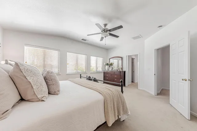a bathroom with a double vanity sink a large mirror a bathtub and next to a window