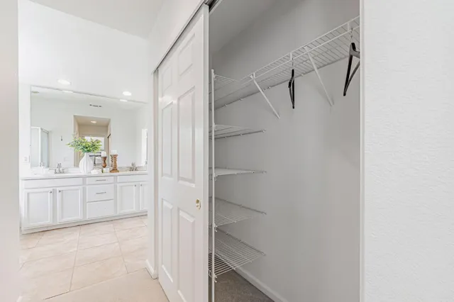 a spacious bathroom with a tub sink and mirror