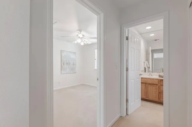 a view of a room with a ceiling fan and a window