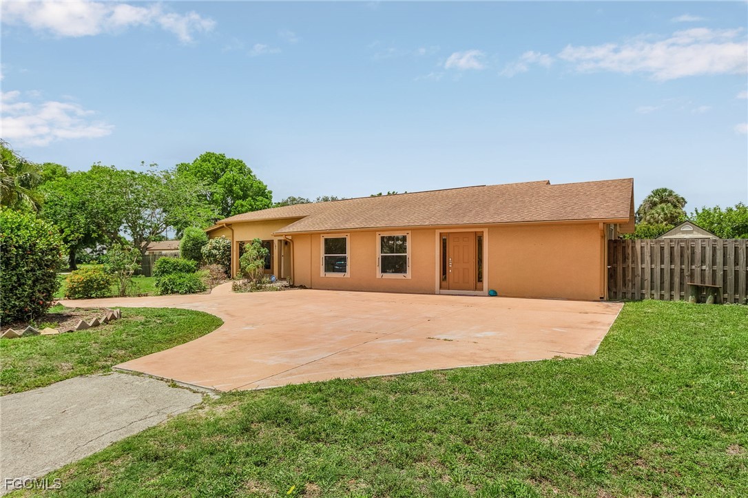 a front view of a house with yard and green space