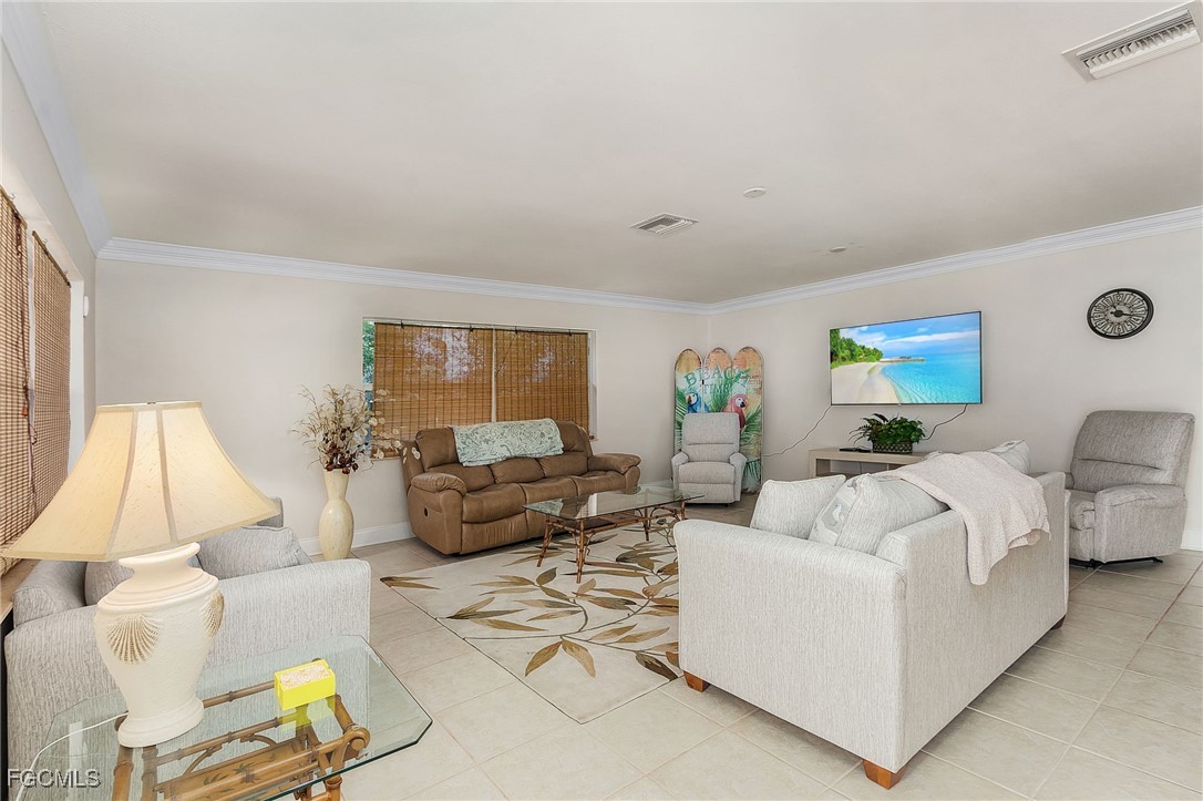 5730 Winkler Road Fort Myers, FL 33919 - Photo 14 of 37 a living room with furniture and a lamp