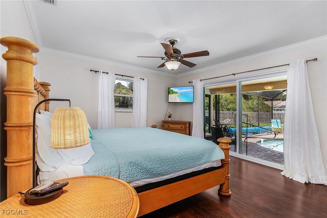 5730 Winkler Road Fort Myers, FL 33919 - Photo 17 of 37 a bedroom with a bed and wooden floor