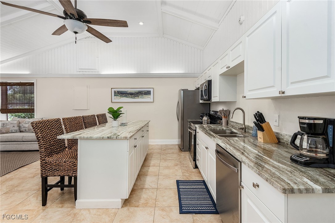 5730 Winkler Road Fort Myers, FL 33919 - Photo 10 of 37 a kitchen with stainless steel appliances a stove a sink a refrigerator a center island and furniture