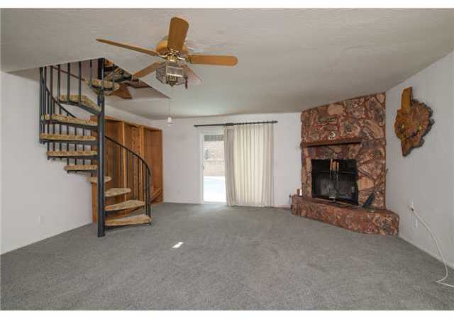 10444 Timberlane Way Santee, CA 92071 - Photo 4 of 12 EXPANDED FAMILY ROOM WITH 1 OF 2 FIREPLACES. SPIRAL STAIRCASE LEADS TO CROWS NEST / TIKI BAR/ VIEW DECK