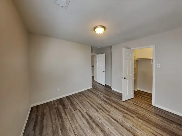 a view of an empty room and wooden floor